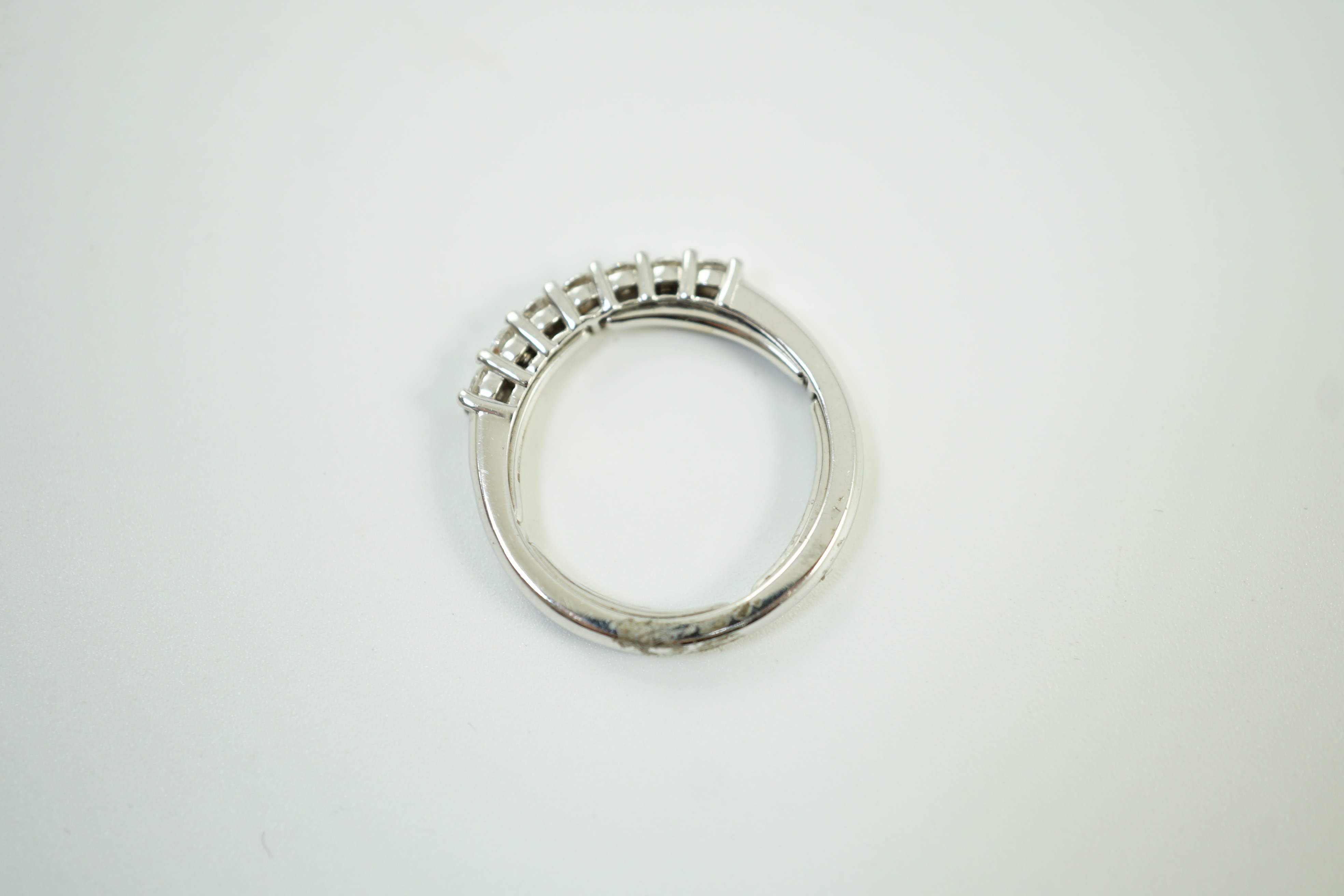 A modern Italian 18ct white gold and seven stone diamond set half hoop ring, size N, gross weight 3.9 grams.